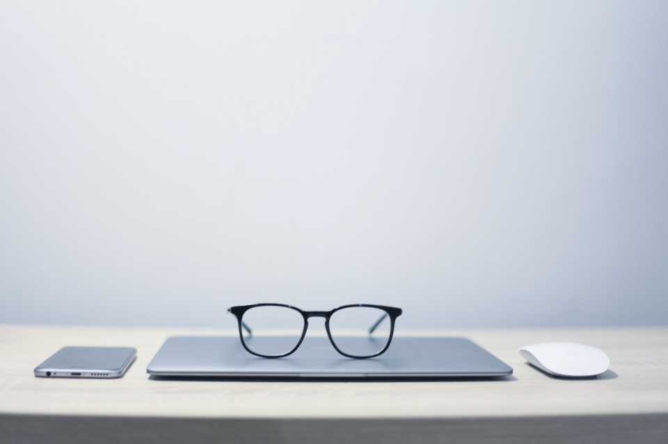photo of glasses with laptop